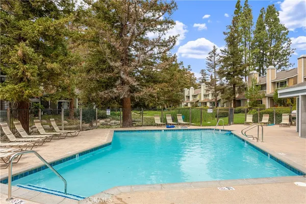 a swimming pool with outdoor seating and yard