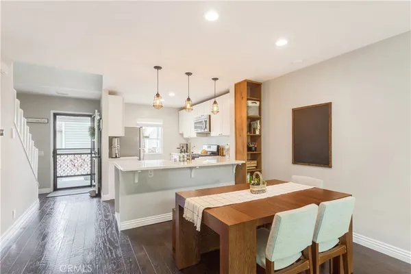 a large kitchen with a table and chairs in it