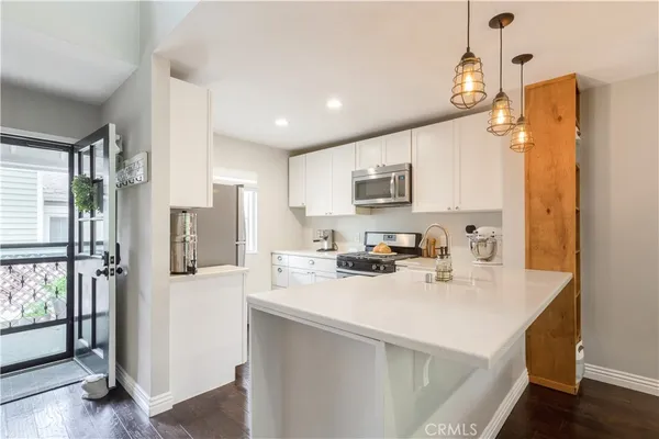 a kitchen with stainless steel appliances a refrigerator sink and cabinets