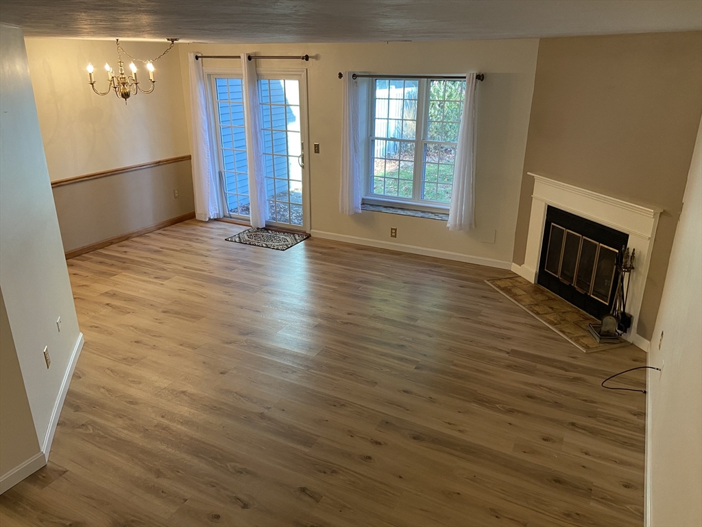 501 Ridgefield Circle, Unit B Clinton, MA 01510 - Photo 7 of 17 a view of an empty room with window and wooden floor