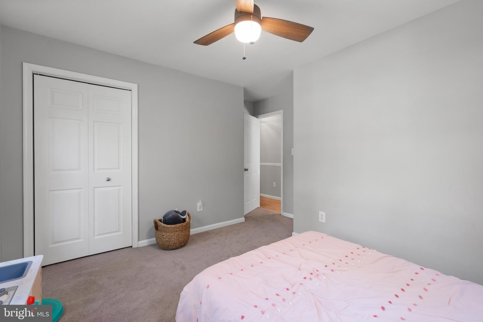 11619 Big Sandy Run Road Lusby, MD 20657 - Photo 18 of 31 a bedroom with a bed and a chandelier