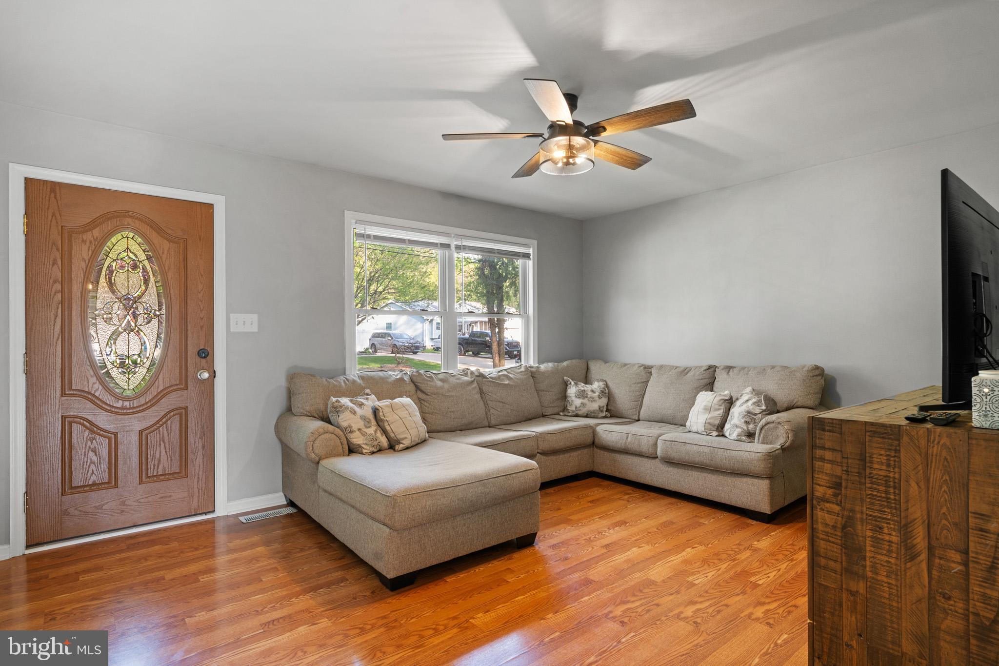 11619 Big Sandy Run Road Lusby, MD 20657 - Photo 3 of 31 a living room with furniture a clock and a window
