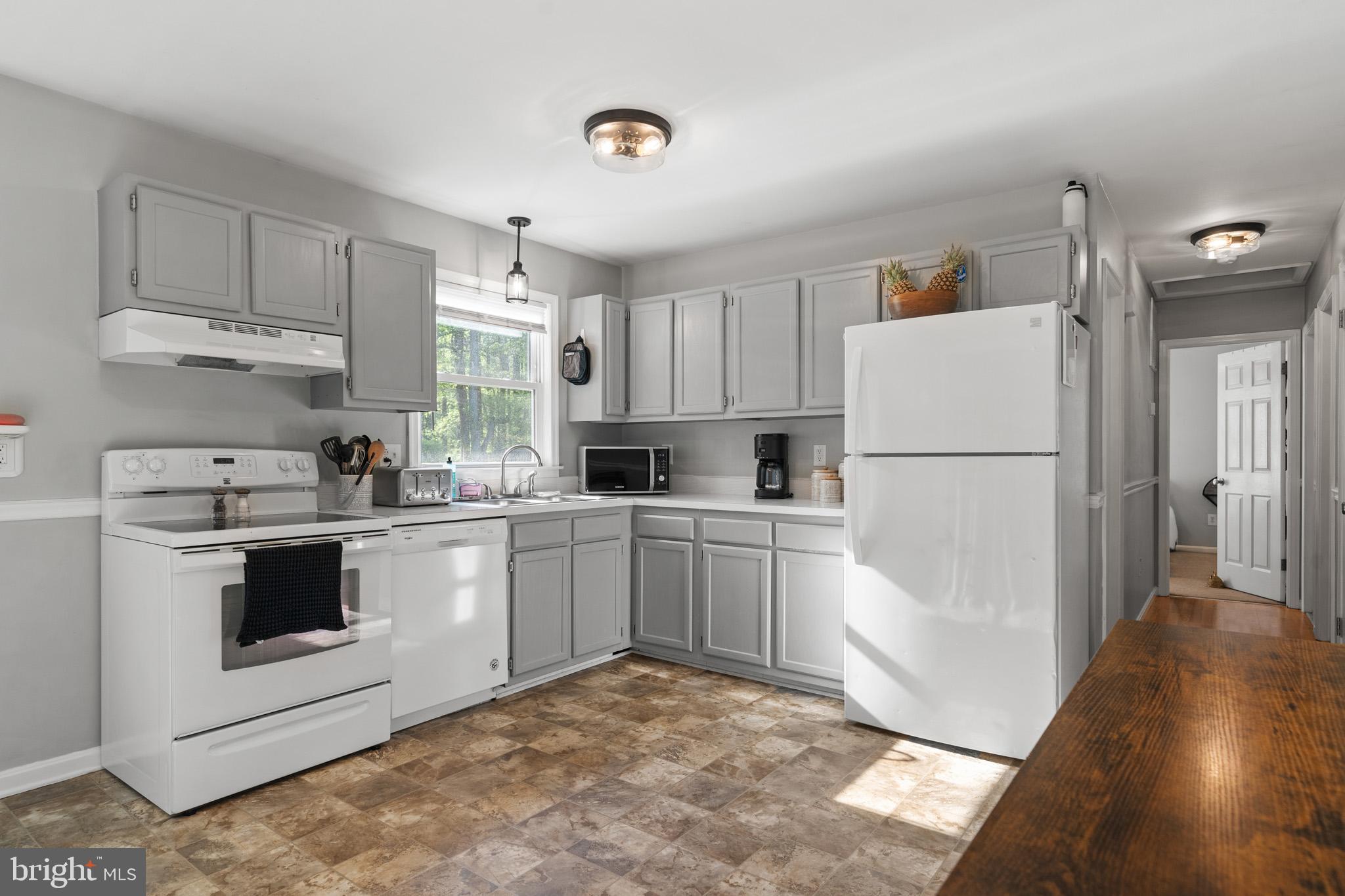 11619 Big Sandy Run Road Lusby, MD 20657 - Photo 5 of 31 a kitchen with a stove a refrigerator and a sink