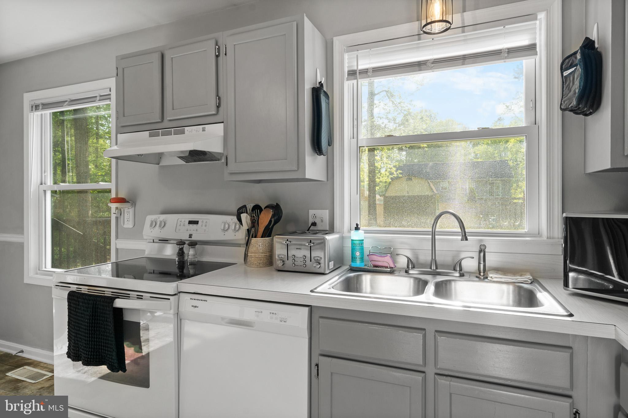 11619 Big Sandy Run Road Lusby, MD 20657 - Photo 8 of 31 a kitchen with appliances a sink and a window