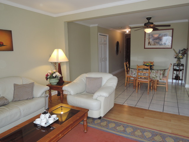 124 East Bailey Road, Unit L Naperville, IL 60565 - Photo 4 of 19 a living room with furniture a rug and a lamp