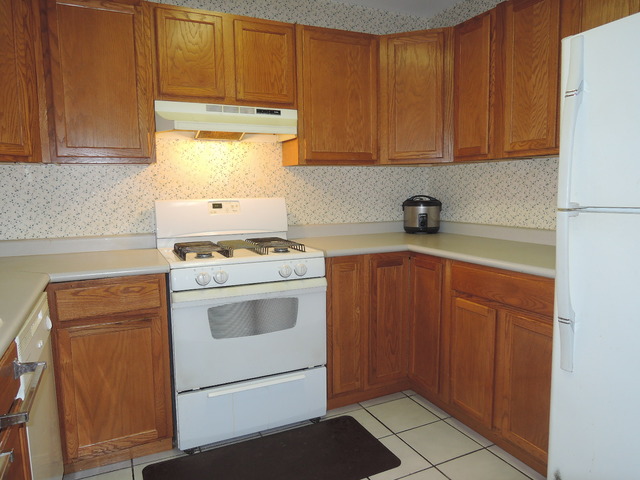 124 East Bailey Road, Unit L Naperville, IL 60565 - Photo 6 of 19 a kitchen with appliances cabinets and a counter top space