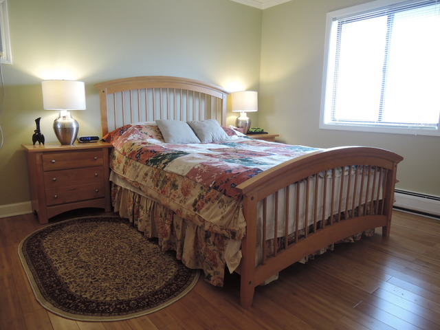 124 East Bailey Road, Unit L Naperville, IL 60565 - Photo 9 of 19 a bed sitting in a bedroom next to a window