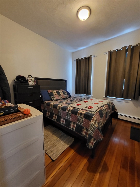 12 Watts Street, Unit 1 Chelsea, MA 02150 - Photo 11 of 29 a bedroom with a bed and a dresser
