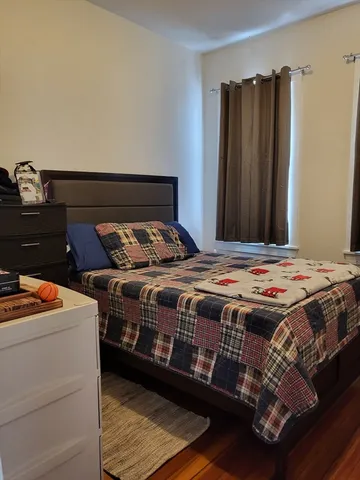 a bedroom with a bed and a dresser