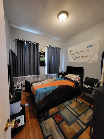 a bed sitting in a bedroom next to a window