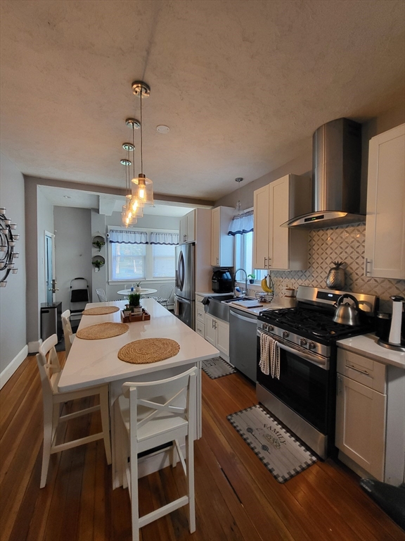 12 Watts Street, Unit 1 Chelsea, MA 02150 - Photo 20 of 29 a kitchen with stove a sink and chairs