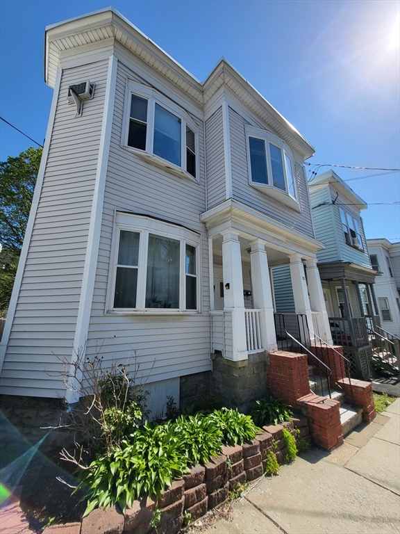 12 Watts Street, Unit 1 Chelsea, MA 02150 - Photo 2 of 29 a front view of a house with a yard