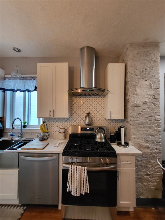 12 Watts Street, Unit 1 Chelsea, MA 02150 - Photo 21 of 29 a kitchen with a sink stove top oven and cabinets