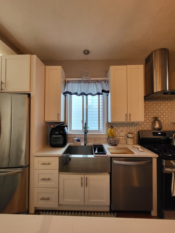 12 Watts Street, Unit 1 Chelsea, MA 02150 - Photo 22 of 29 a kitchen with stainless steel appliances a sink a stove a refrigerator and cabinets