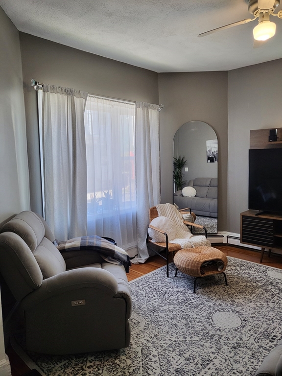 12 Watts Street, Unit 1 Chelsea, MA 02150 - Photo 3 of 29 a living room with furniture and a flat screen tv