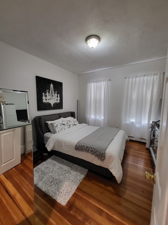 12 Watts Street, Unit 1 Chelsea, MA 02150 - Photo 9 of 29 a bedroom with a bed and a couch