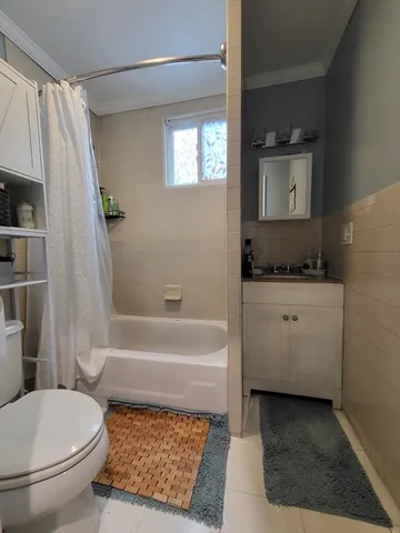 a bathroom with a sink a toilet and bathtub