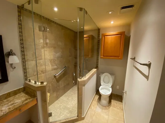 a bathroom with a toilet and a shower