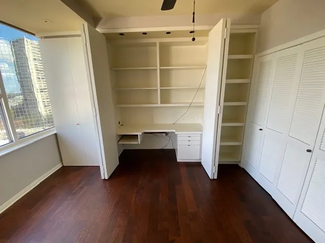 a view of walk in closet with empty racks