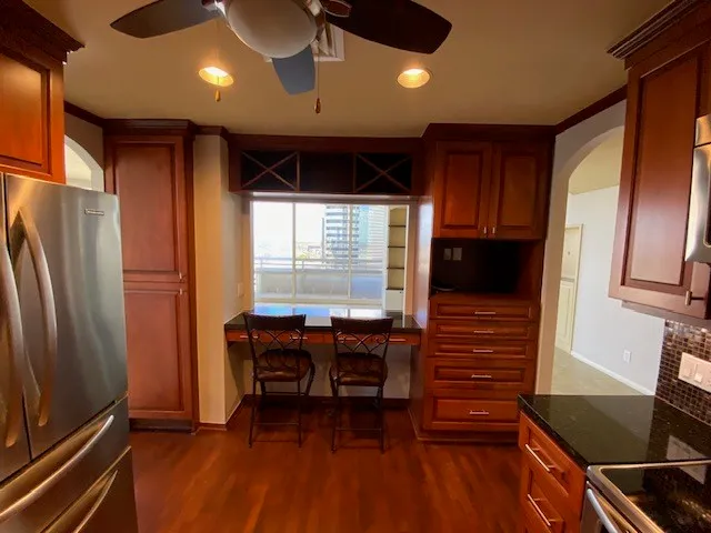 a kitchen with stainless steel appliances granite countertop a refrigerator and a stove top oven