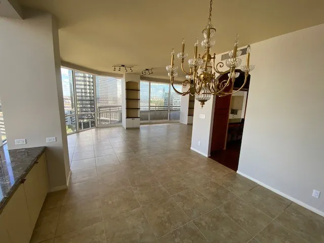 a view of a living room and chandelier in kitchen