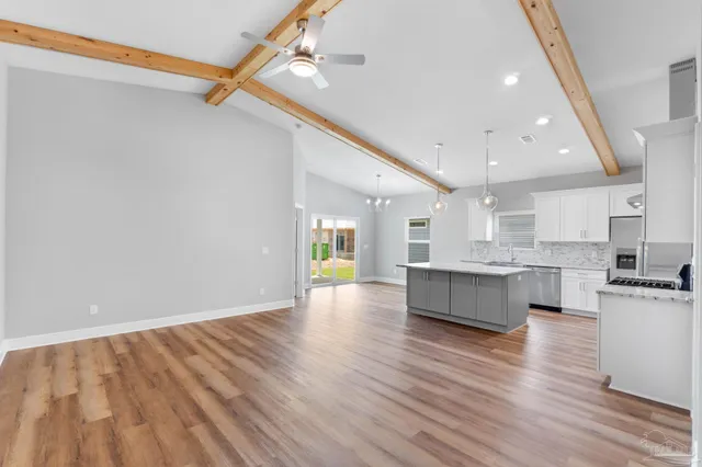 a view of kitchen with sink microwave and stove