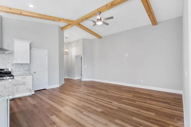 a view of a kitchen with wooden floor and a sink