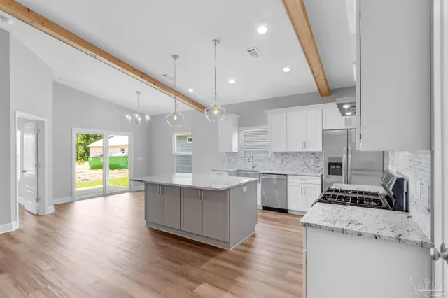 a kitchen with stove and cabinets