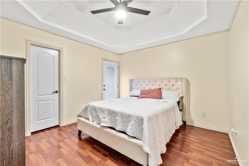 1309 West Fig Avenue, Unit C Pharr, TX 78577 - Photo 14 of 20 a bedroom with a bed and a ceiling fan