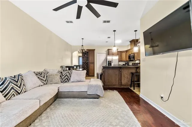 a living room with furniture and kitchen view