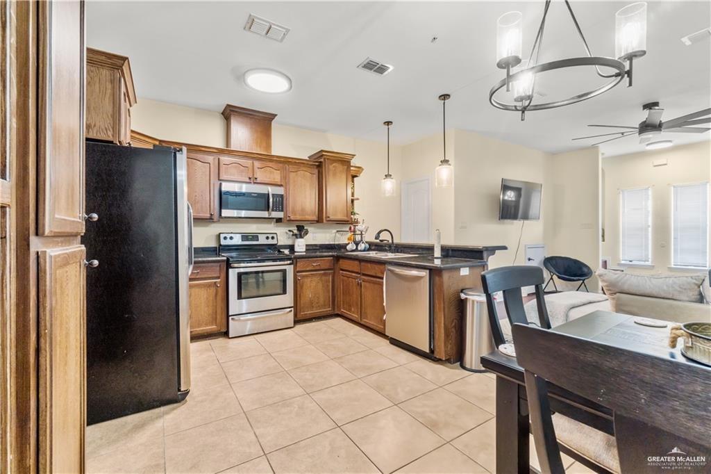 1309 West Fig Avenue, Unit C Pharr, TX 78577 - Photo 9 of 20 a kitchen with a refrigerator a sink and appliances
