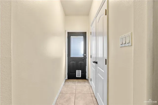 a view of a hallway with wooden shelves