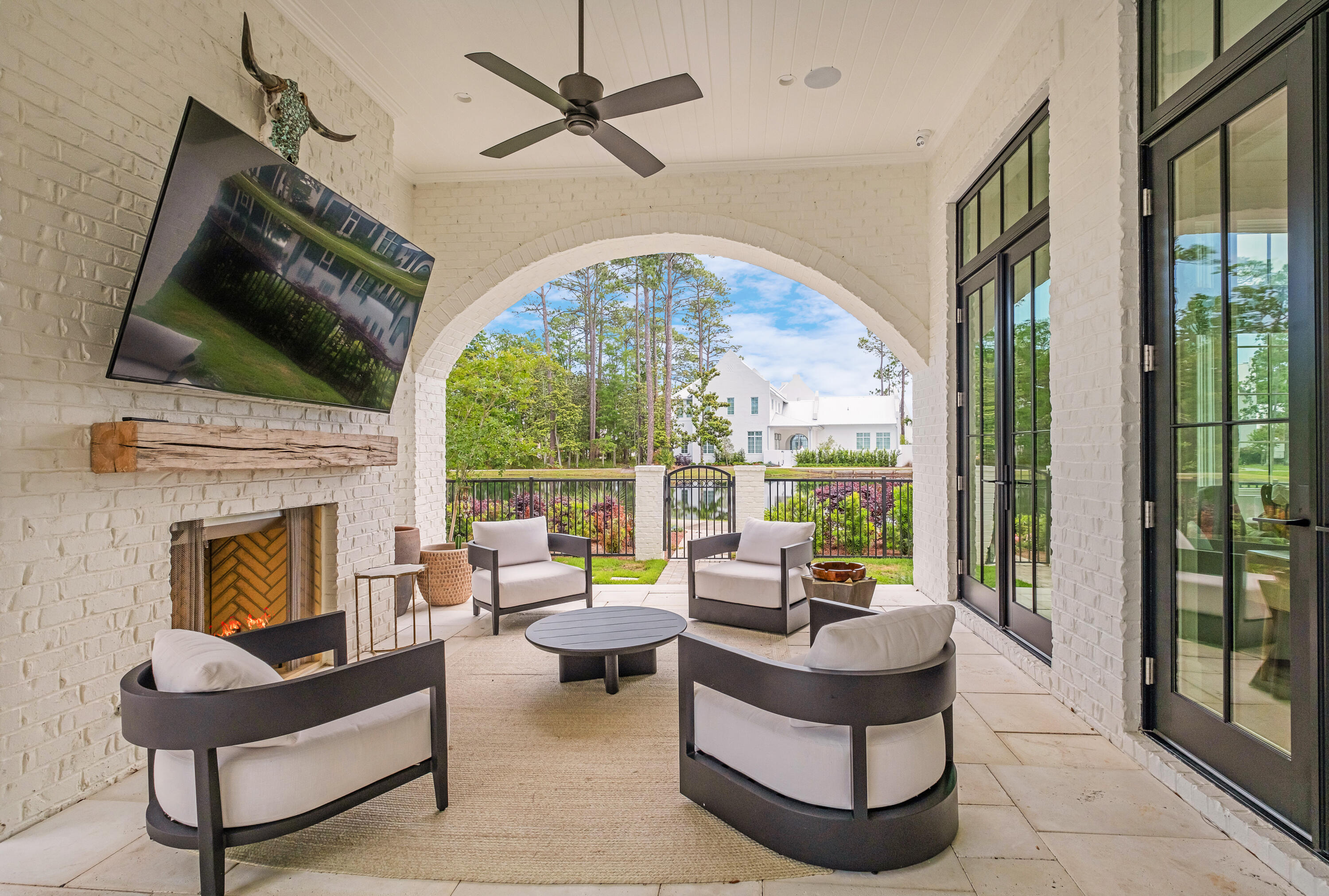 83 Tyler Drive Santa Rosa Beach, FL 32459 - Photo 20 of 68 a living room with furniture a fireplace and a floor to ceiling window