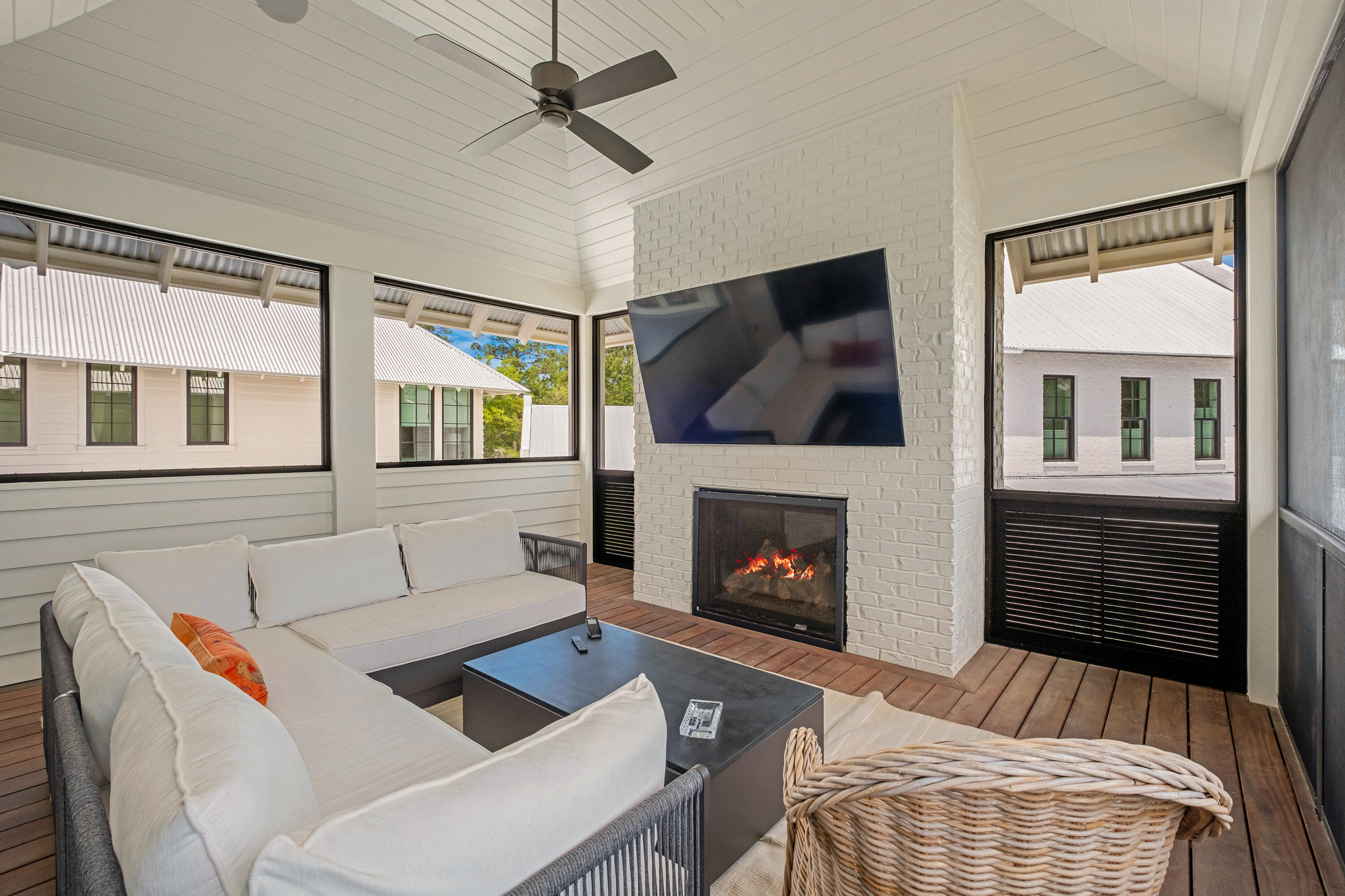 83 Tyler Drive Santa Rosa Beach, FL 32459 - Photo 40 of 68 a living room with furniture a flat screen tv and a fireplace