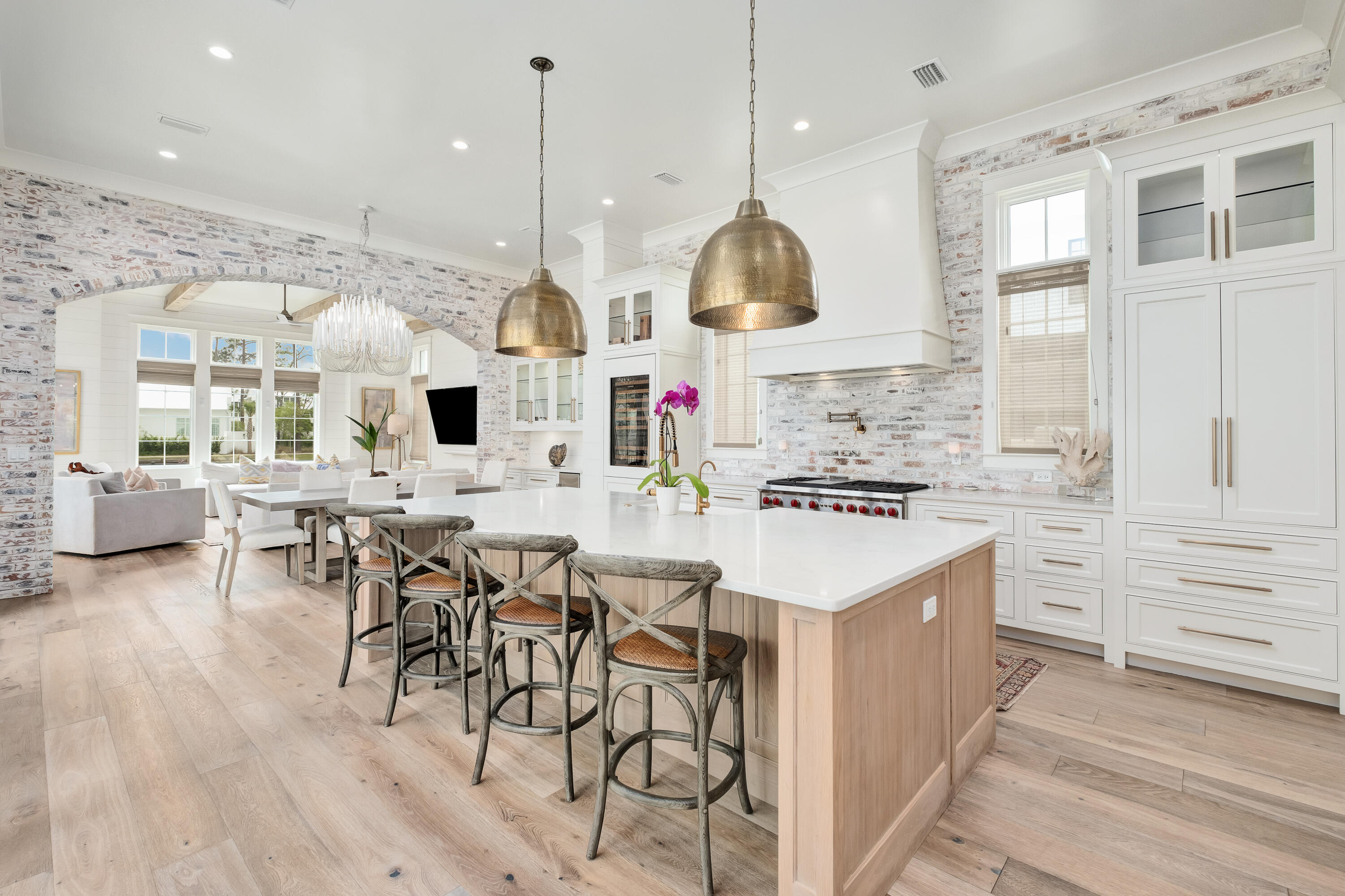 83 Tyler Drive Santa Rosa Beach, FL 32459 - Photo 7 of 68 a kitchen with stainless steel appliances kitchen island granite countertop a stove a sink a oven and a dining table with wooden floor