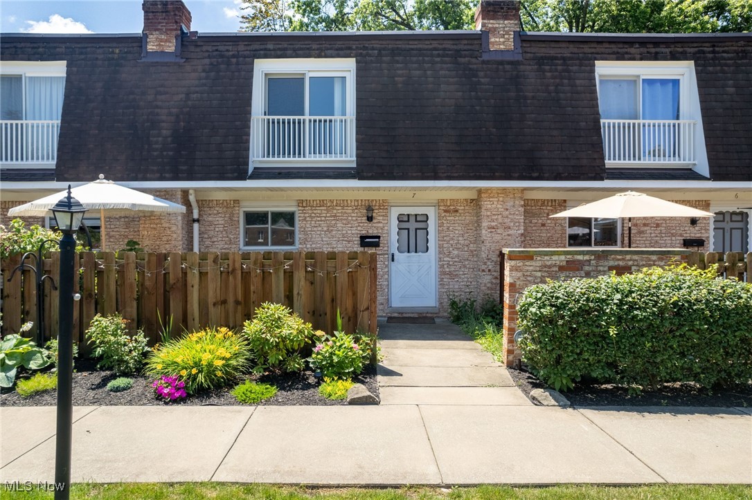 6480 State Road, Unit F7 Parma, OH 44134 - Photo 1 of 33 Townhome / multi-family property with mansard roof, a chimney, brick siding, and a shingled roof