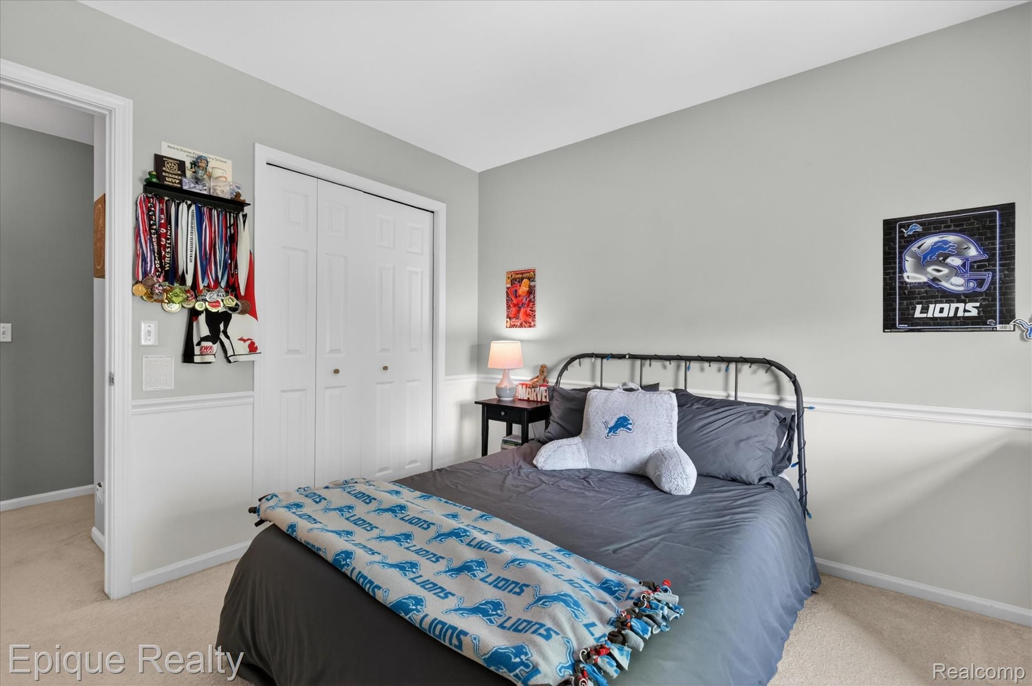 760 Caribou Court Rochester, MI 48307 - Photo 28 of 67 Carpeted bedroom featuring neutral grey walls with white wainscoting, a double bi-fold closet, and a white trim doorway