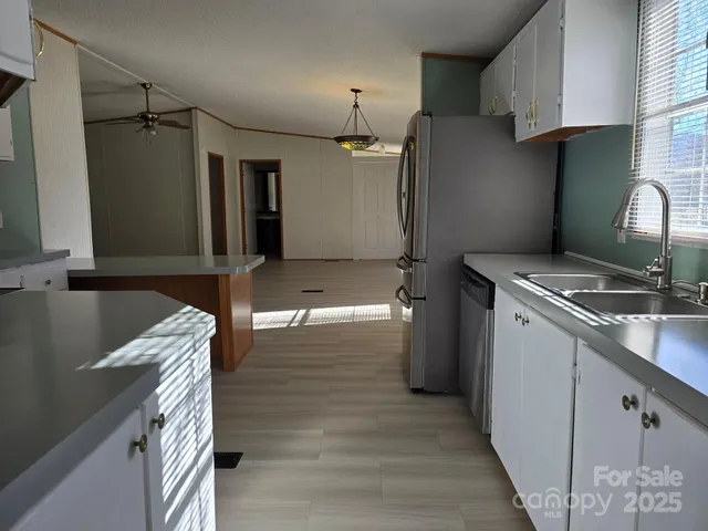 a kitchen that has a sink a refrigerator and a stove