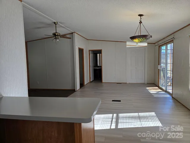 a view of a room with wooden floor