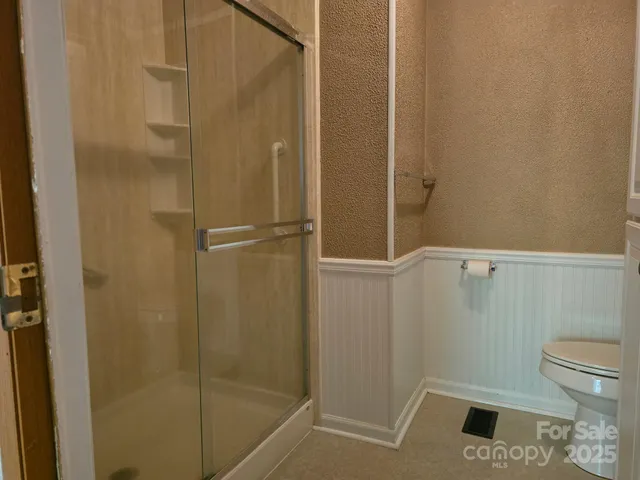 a bathroom with a shower and toilet