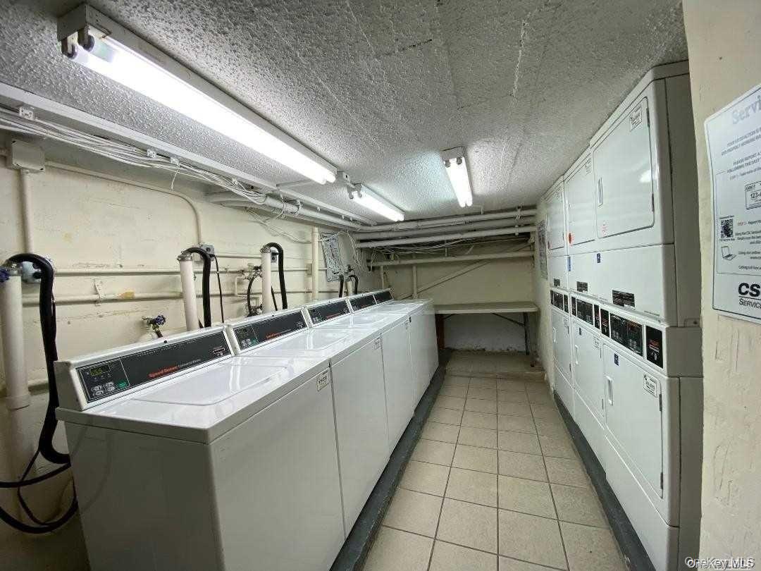 310 Riverside Boulevard, Unit 5H Long Beach, NY 11561 - Photo 12 of 13 a storage room with washer and dryer