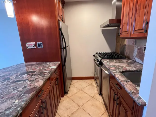 a kitchen that has a sink and a stove