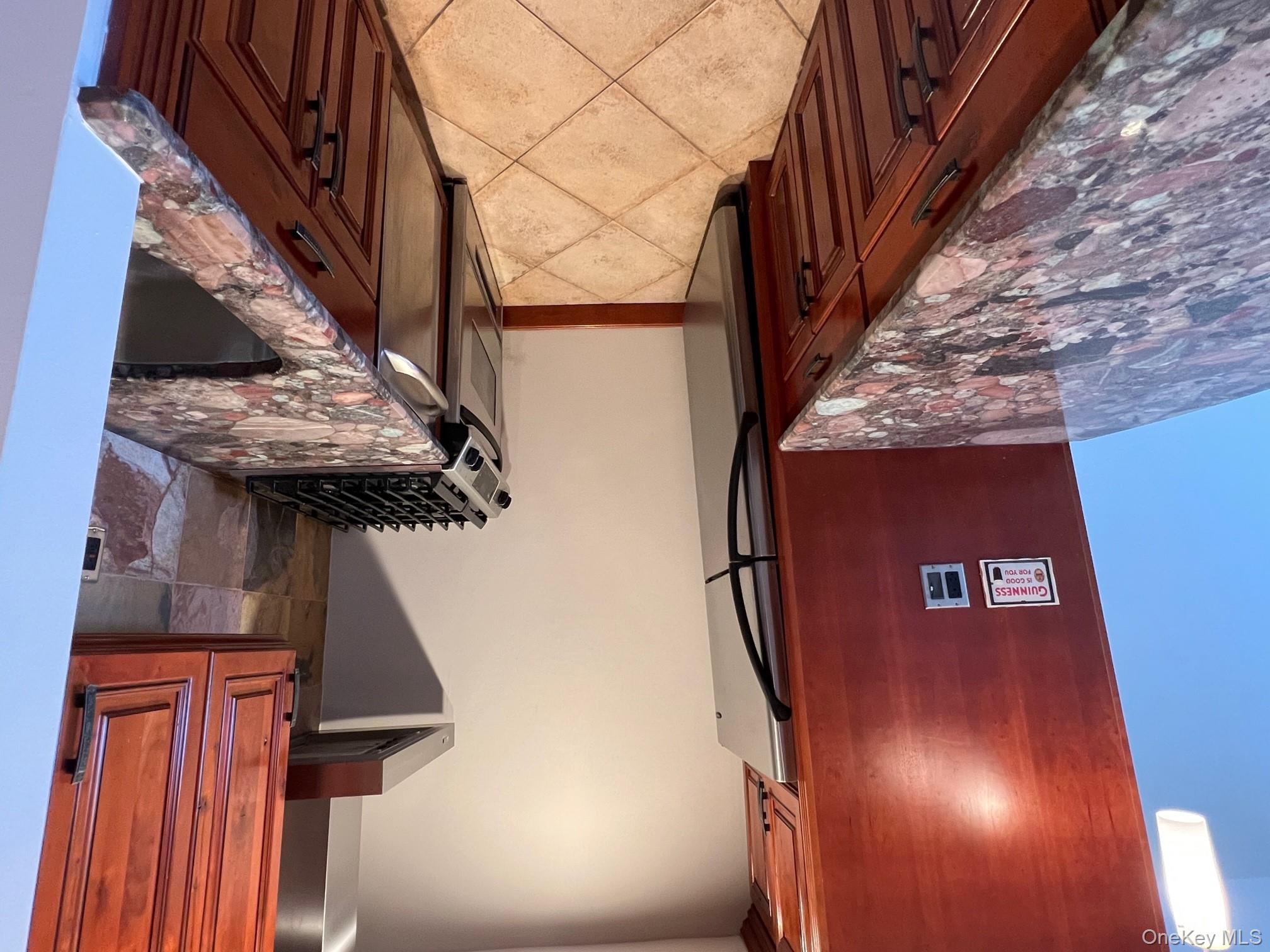 310 Riverside Boulevard, Unit 5H Long Beach, NY 11561 - Photo 5 of 13 a kitchen that has a sink and a stove