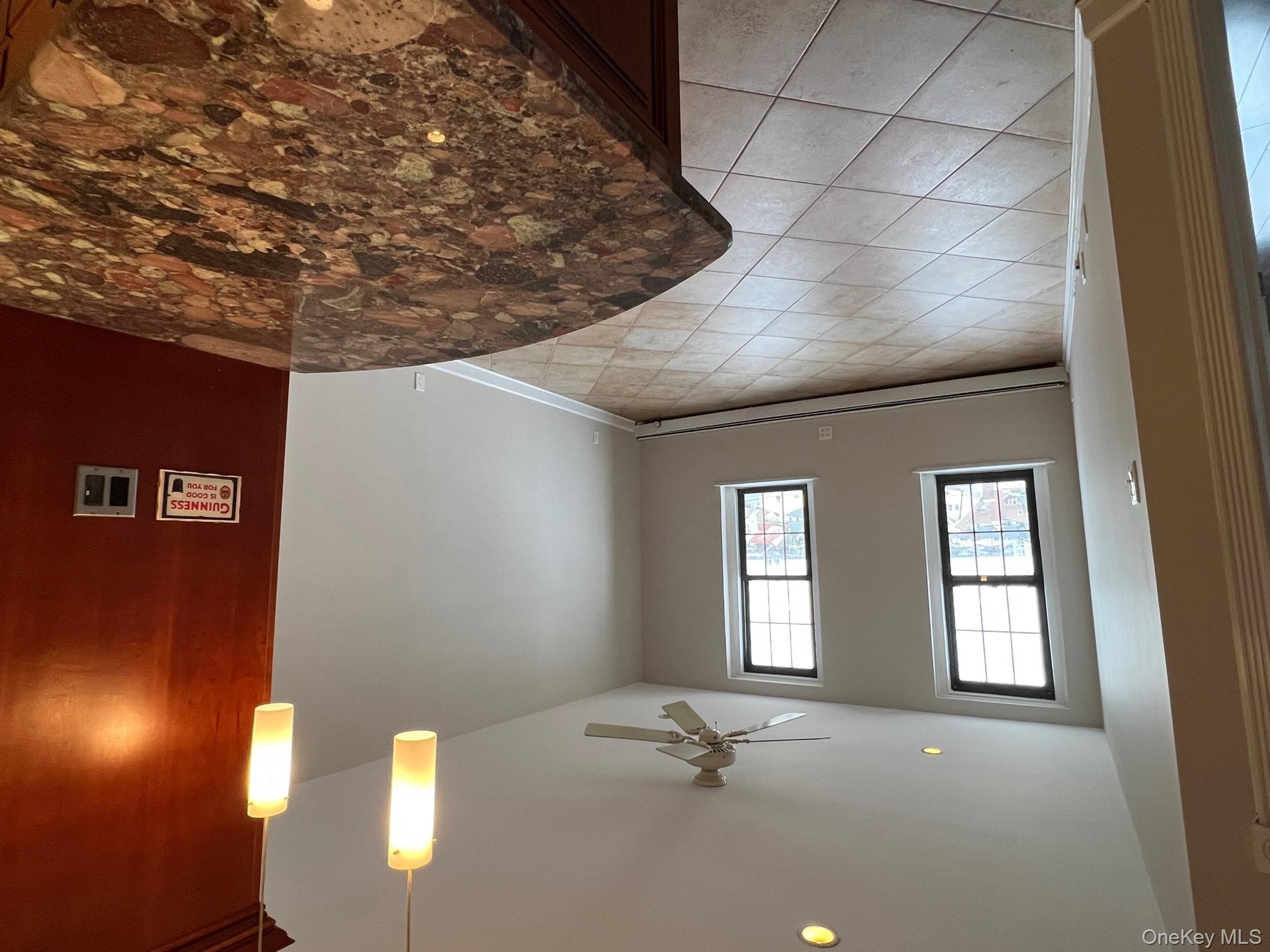 310 Riverside Boulevard, Unit 5H Long Beach, NY 11561 - Photo 7 of 13 a view of an empty room and window