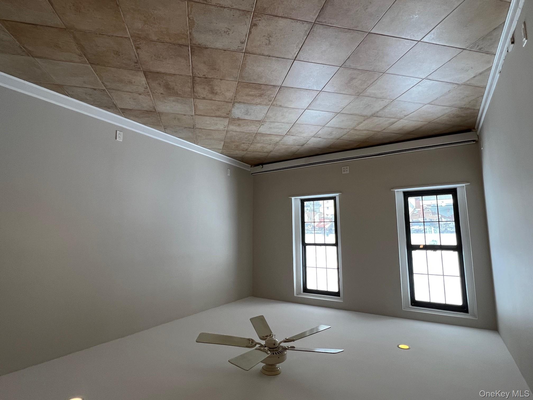 310 Riverside Boulevard, Unit 5H Long Beach, NY 11561 - Photo 8 of 13 a view of an empty room with a window