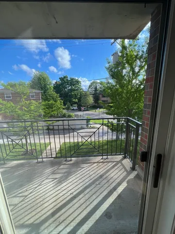 a view of balcony with wooden floor and fence