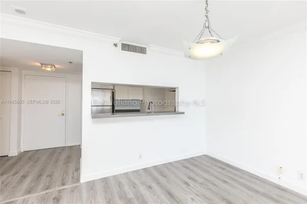 a view of a room with wooden floor and cabinet