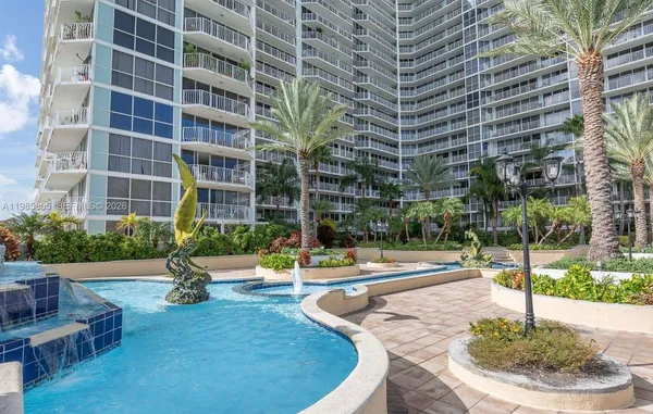 a view of a building with garden and sitting area