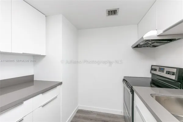 a kitchen with stainless steel appliances a sink and a refrigerator