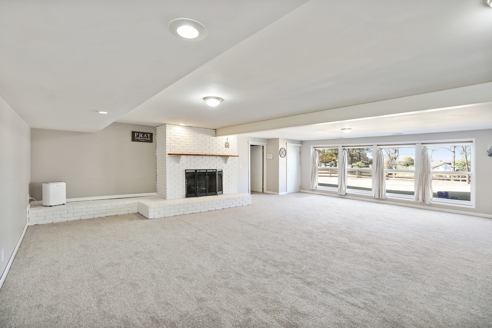 676 Ferguson Hill Road Lafayette, TN 37083 - Photo 51 of 89 a view of an empty room with a fireplace and a large window